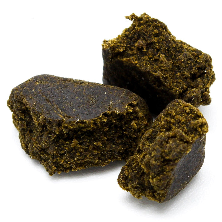 Traditional Afghan Black Hash concentrate with dark exterior texture and resin-rich appearance.